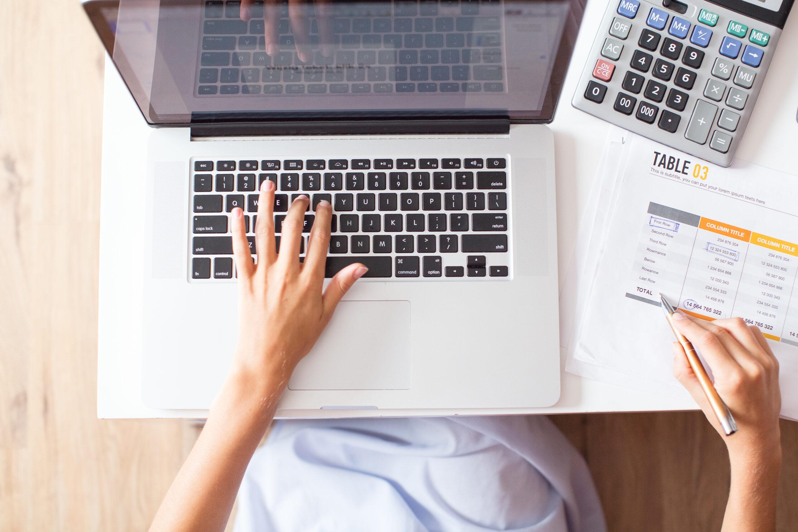 Cropped View of Accountant Working on Laptop